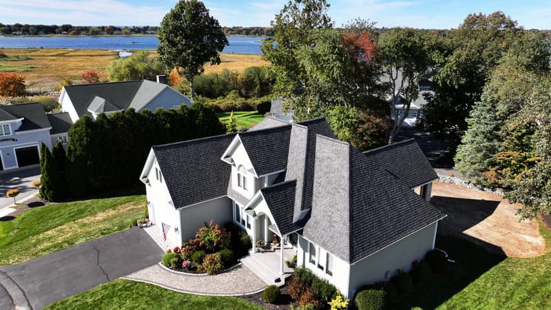 Dark asphalt shingle roof on a two-story house seen from above