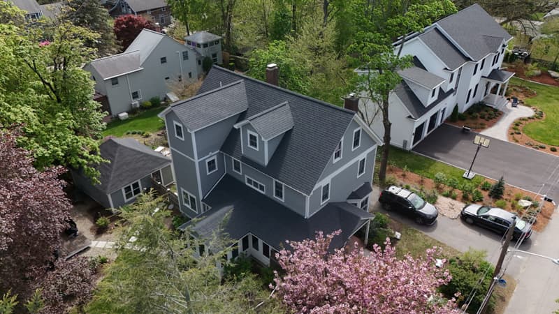 Gray house with dormers and a dark shingle roof