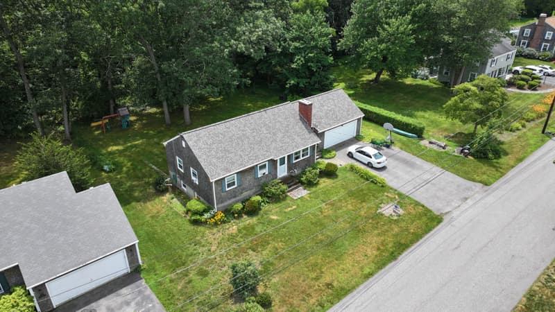 Small gray house with a gray shingle roof