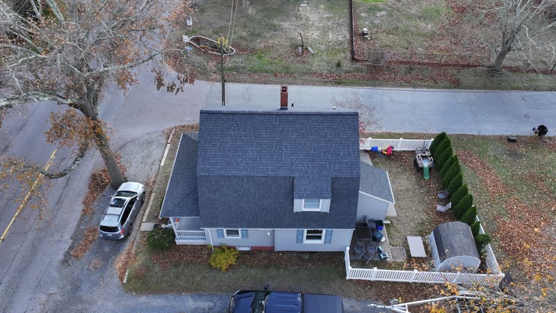 Small house with a dark shingle roof