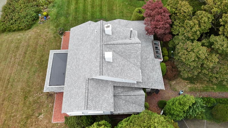 Roof seen from above with a black flat membrane section